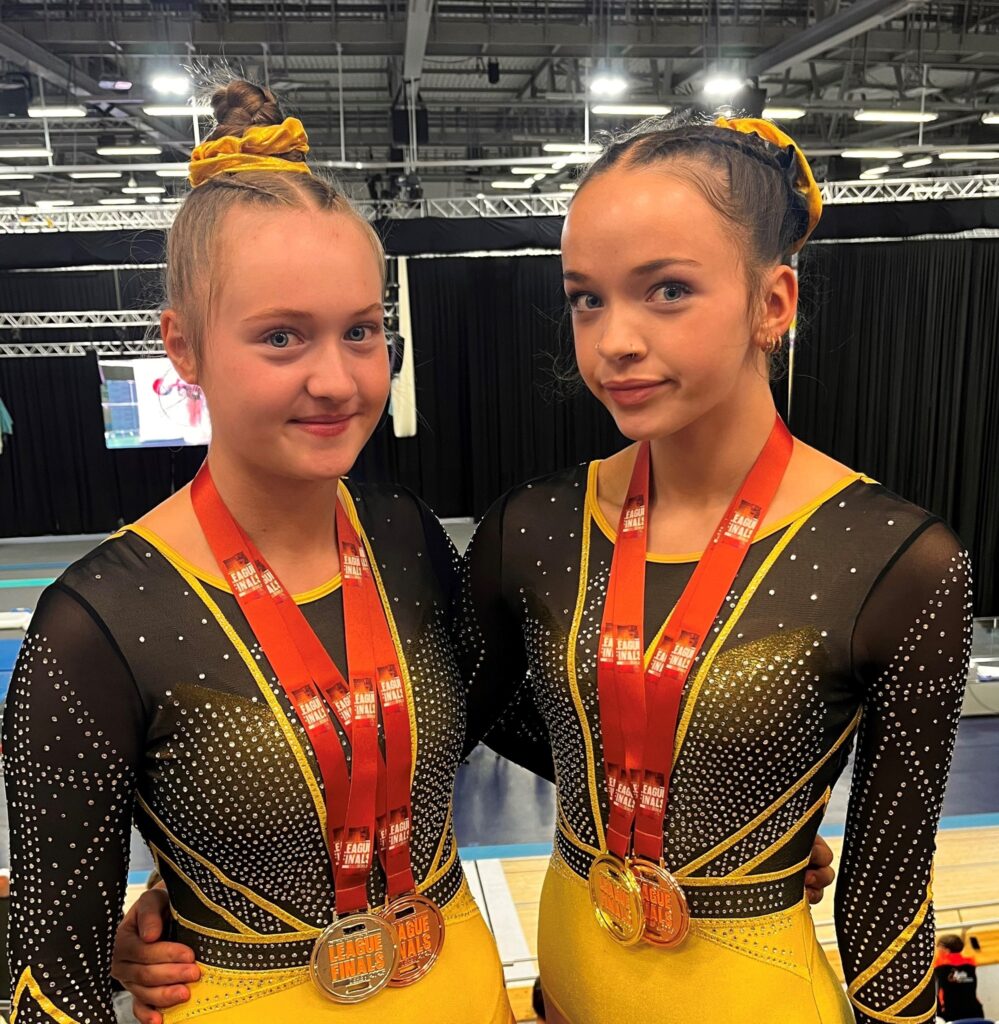 Photo showing Faith and Bobbi bring home medals from the Trampoline League Finals in Derby.